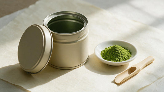 A plain unlabelled matcha tin beside the tea itself