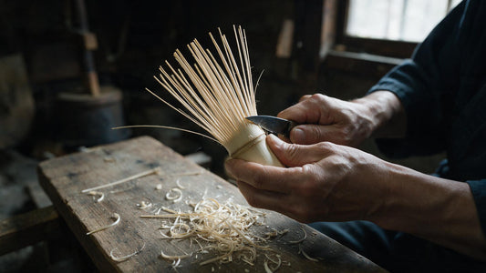 A craftsman splitting cured white bamboo into the fine tines of a tea whisk