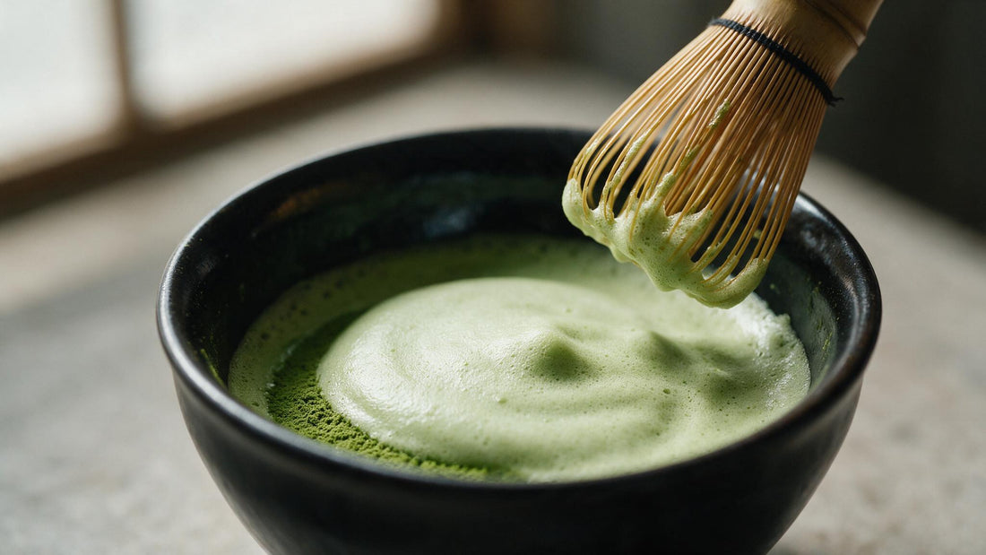 Thick fine foam on a bowl of matcha as the whisk lifts away