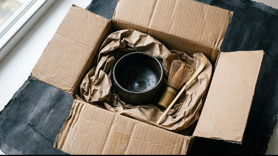An opened gift box with Japanese tea tools packed inside