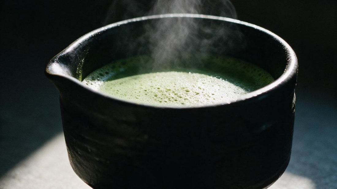 Steam rising from a freshly made bowl of matcha in soft window light