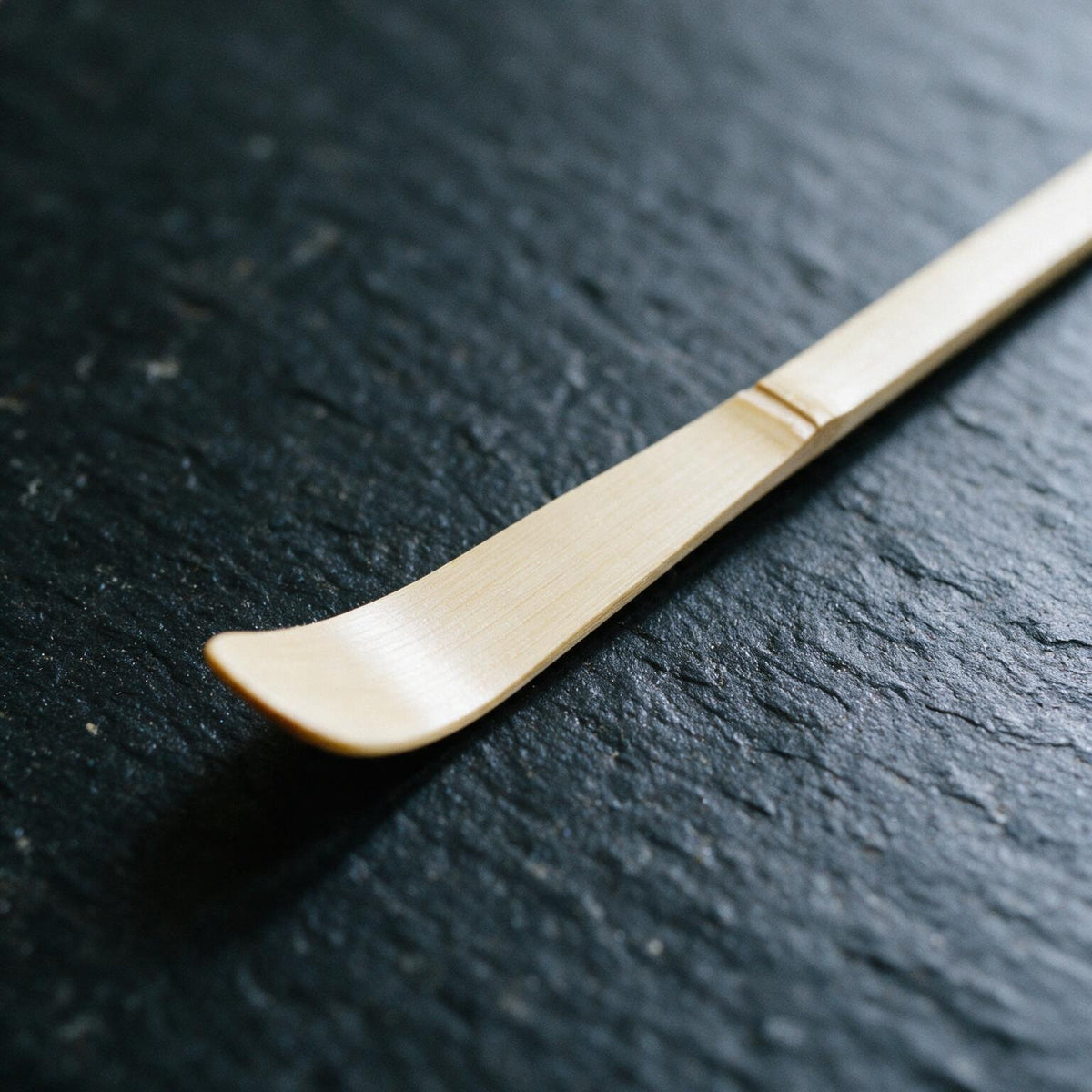 The tip of the chashaku, showing the bamboo node and how shallow the scooping end really is