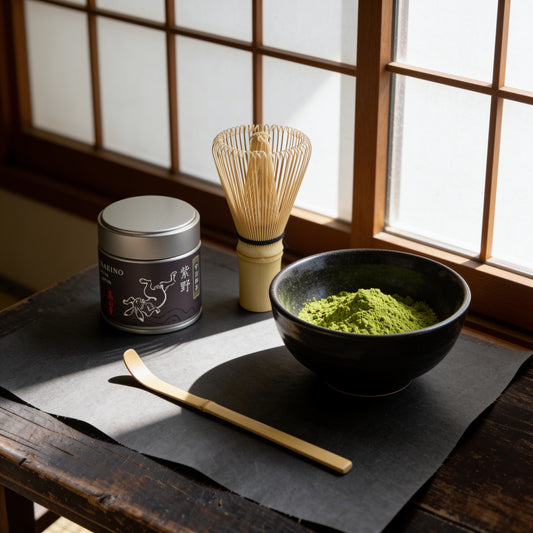 The 30 g tin of Uji matcha "Murasakino" with a black tea bowl, bamboo scoop and whisk by a shoji window (AI-generated image)